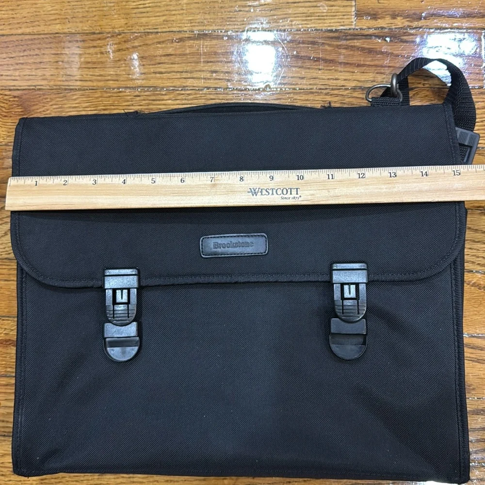 Brookstone black neoprene waterproof lap top bag with detachable shoulder strap.